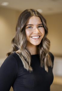 Headshot of a woman in a black shirt smiling