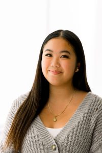 Photo of a woman in a grey sweater