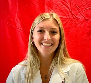 Headshot of a woman with a red background