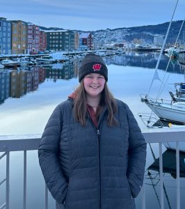 Photo of a woman standing outside in front of a body of water