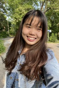 Photo of a woman in a jean jacket smiling