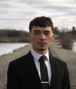 Headshot of a man in a black suit