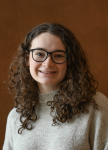 Headshot of a woman in a sweater smiling