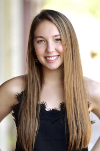 Headshot of a woman in a black shirt smiling