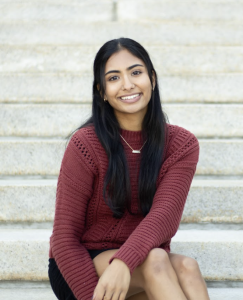 Photo of a woman in a red sweater smiling