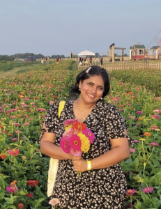 Photo of a woman holding flowers outside