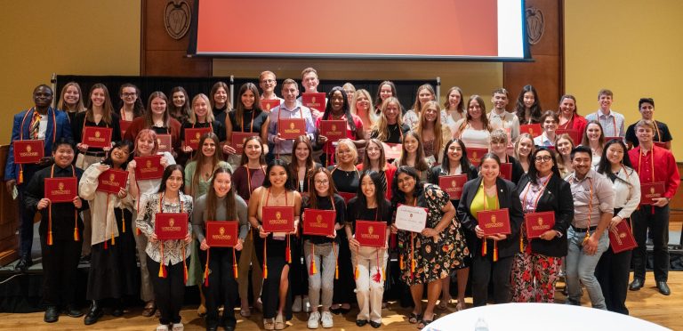 Spring 2024 Leadership Certificate recipients pose and smile as a group.