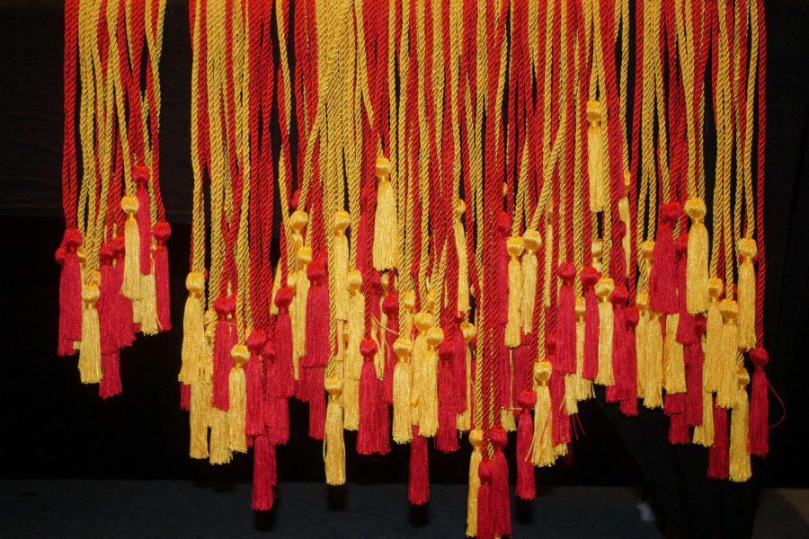 Table of yellow and red leadership certificate cords.