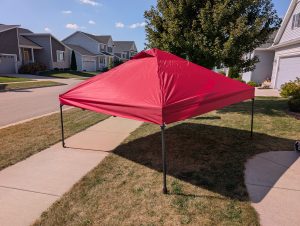 Canopy shelter set up. Red cover on top.