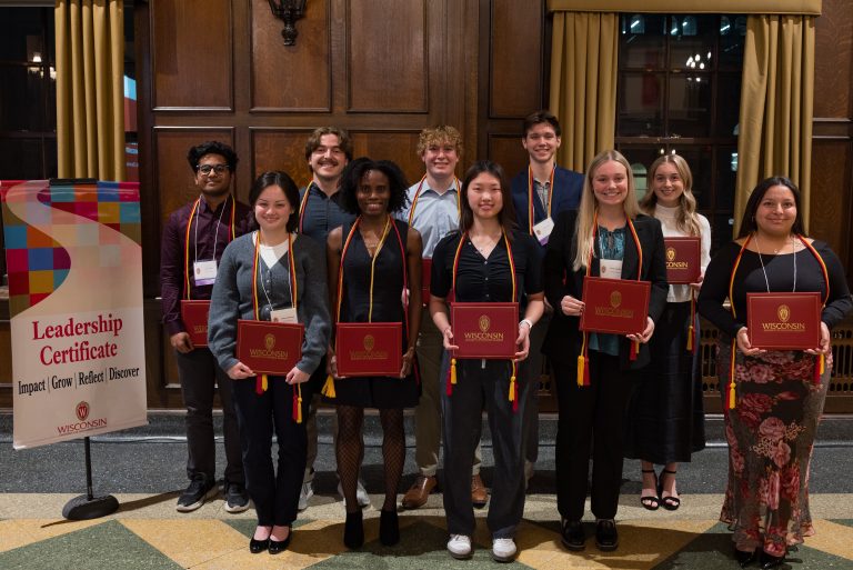 A group of people smiling and holding their certificates