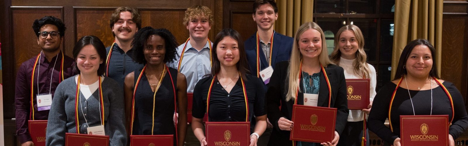 A group of people smiling and holding their certificates