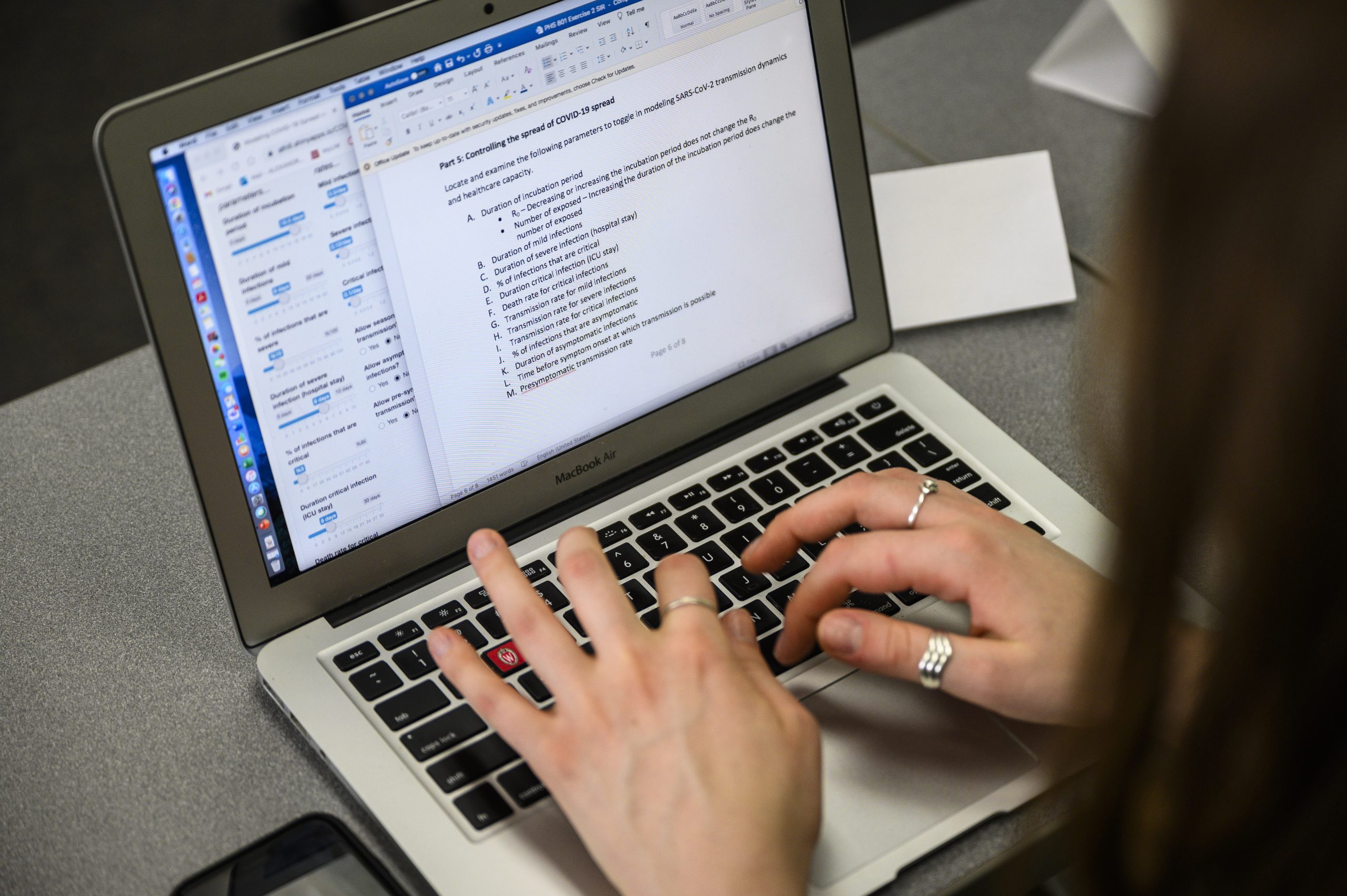 A student working in a Word document on their laptop.