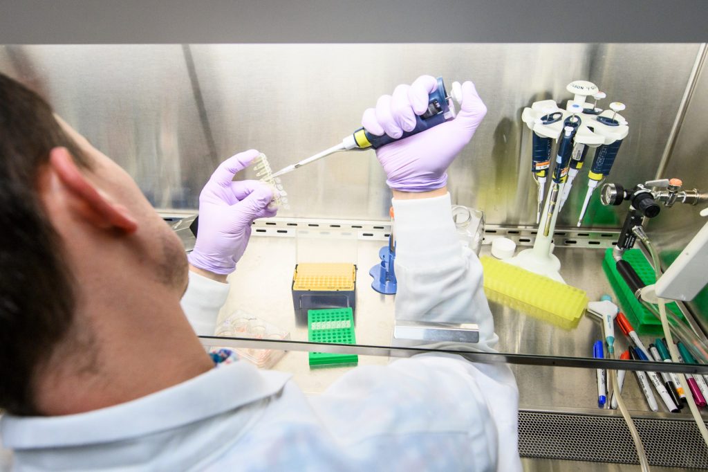 A scientist using a pipet.
