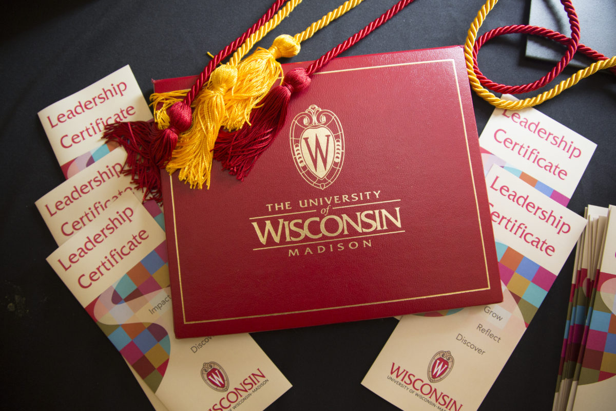 Leadership Certificate brochures, certificate holder and gold and red graduation cords