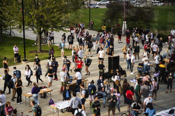 Students walking by Org Fair tables.
