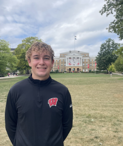 A man smiling in front of bascom hill