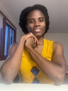 A woman in a yellow top smiling