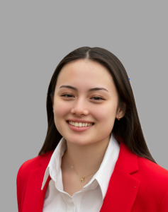 A woman in a red blazer smiling