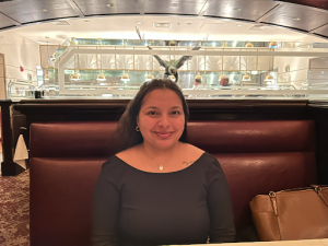 A woman smiling in a booth