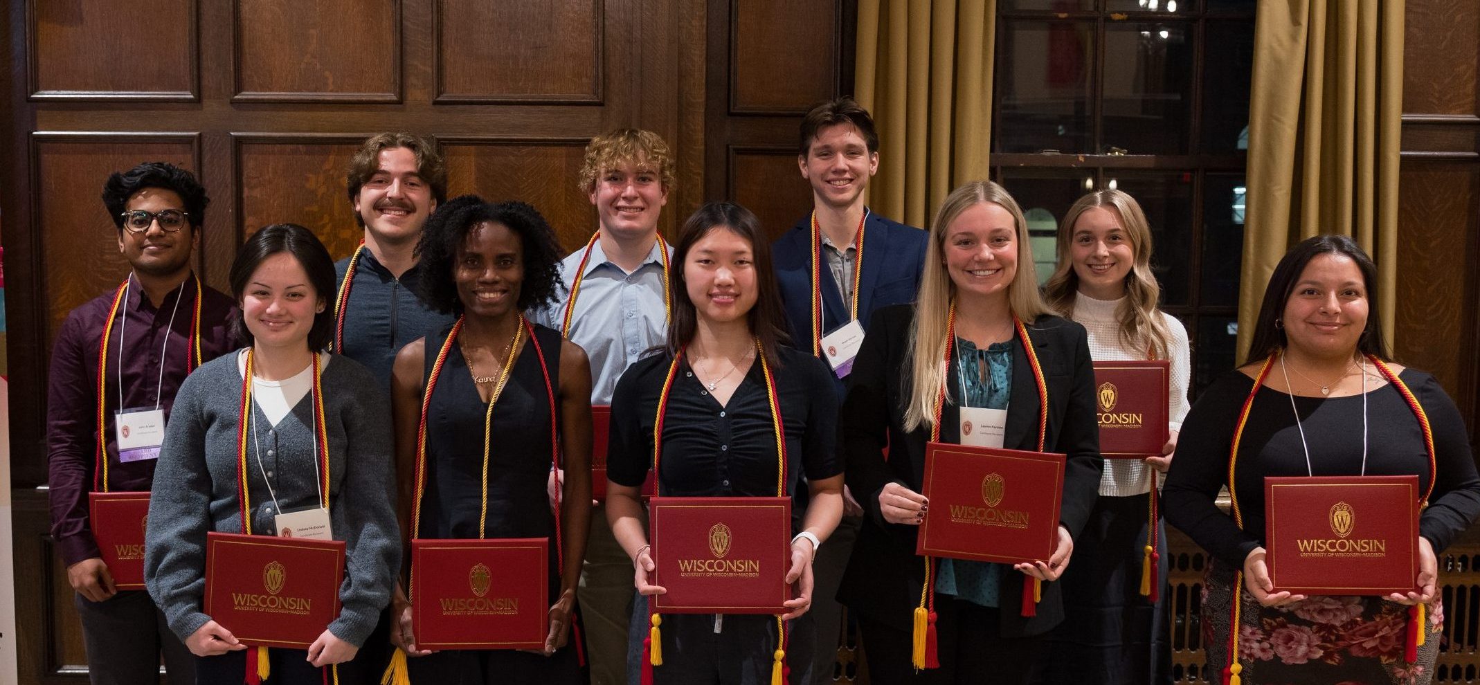 A group of people smiling and holding their certificates