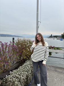 Woman smiling softly near flowers