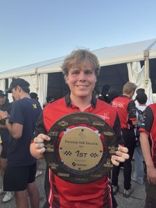 Man smiling holding award