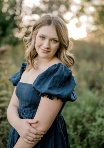 Woman smiling holding her arm