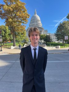 Man smiling in front of capital
