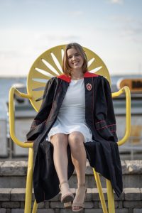 Woman smiling in graduation gown