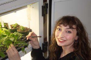 Woman smiling with plants