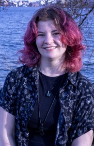 Person smiling by the lake